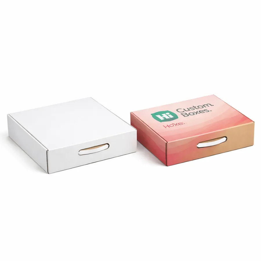Two slim cardboard boxes with carry handles- one plain white and one with pink decorative patterns- class=